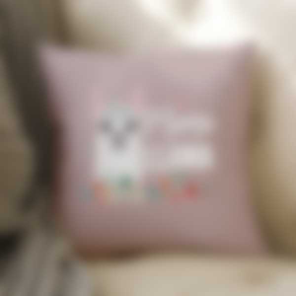A pillow with a printed design lies on a sofa