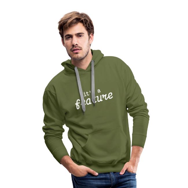 A male model wearing a hoodie with "it's a feature" in the aforementioned font